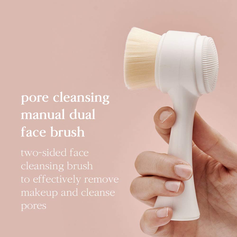 Nooni dual face brush held in hand, for pore and makeup cleansing