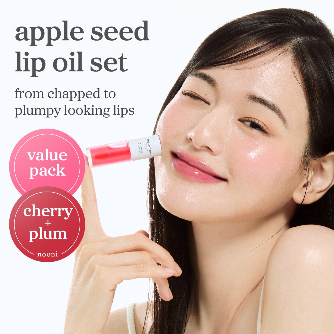 Apple seed lip oil set with cherry and plum shades applied showing glossy lips and value pack offering.
