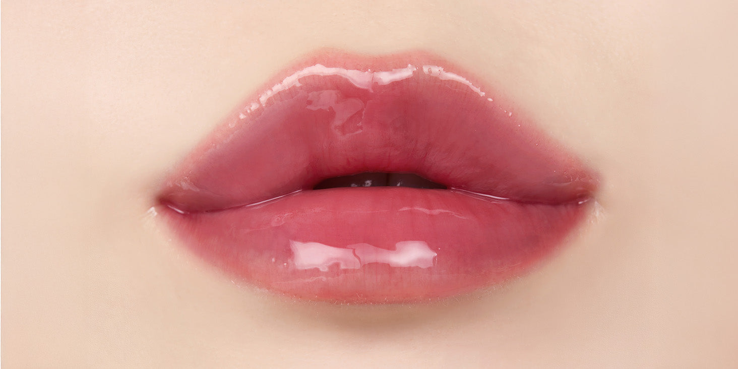 Close up of lips after applying nooni applemulberry lip oil with glossy shine and hydrated appearance.