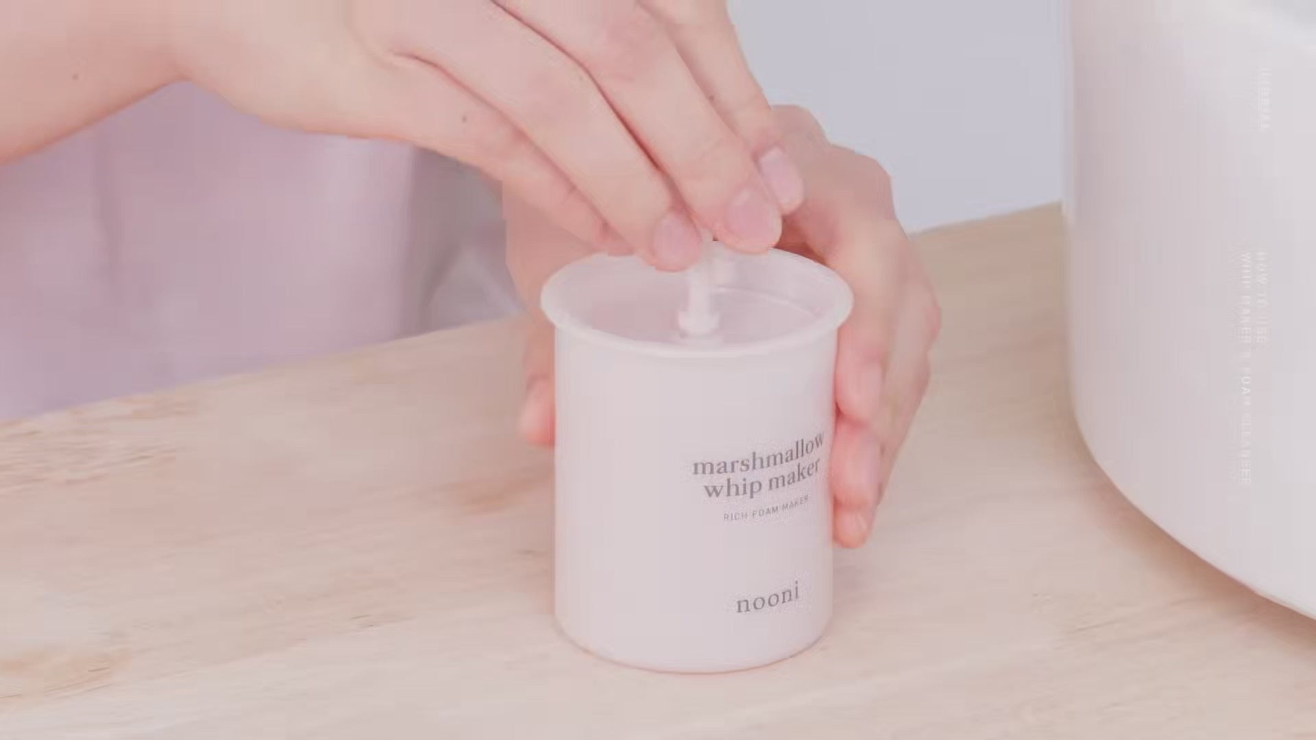 Video showing hands pumping the Nooni Marshmallow Whip Maker to create foam