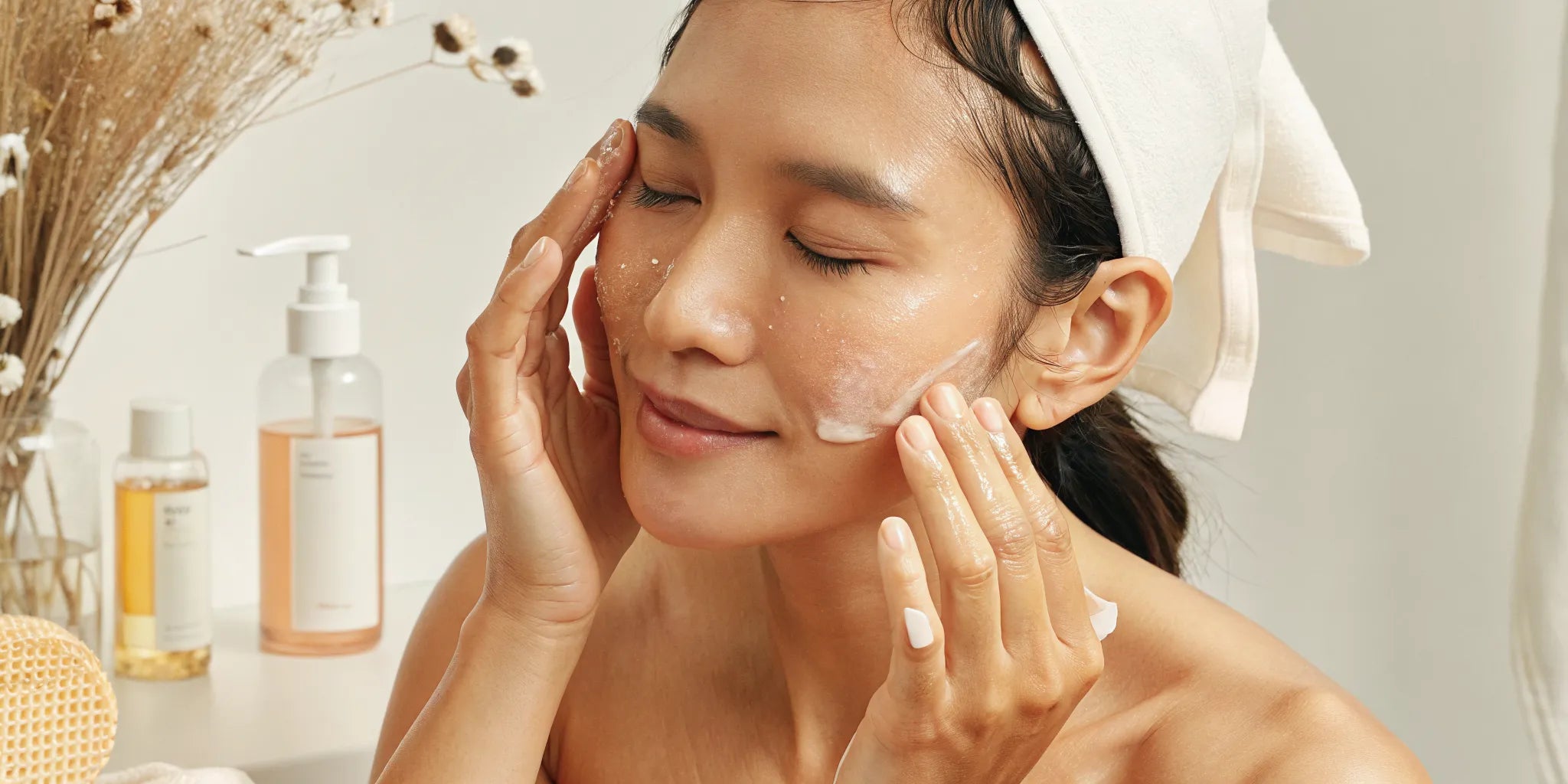 Woman gently massaging cleansing oil onto her face as part of a K-beauty skincare routine