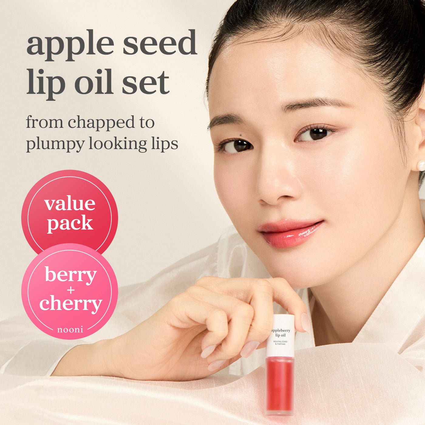 Apple seed lip oil set with berry and cherry shades applied showing glossy lips and value pack offering.