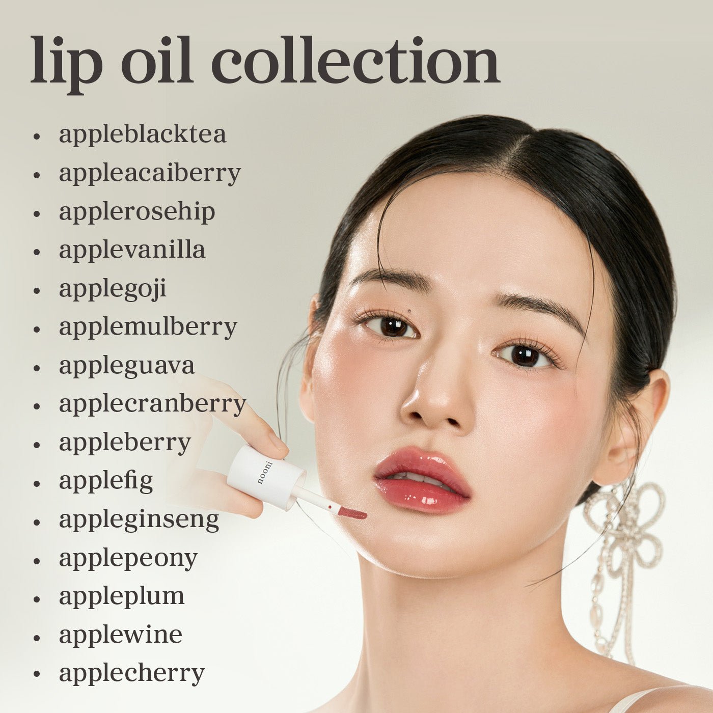 Model applying lip oil from nooni Complete Color Collection 15 pack featuring all nooni lip oil shades.