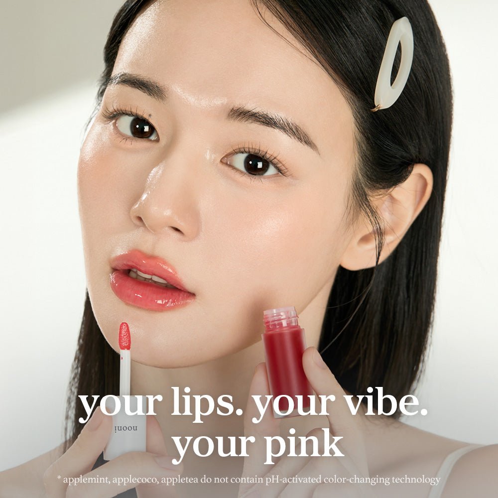 Model applying nooni appleguava lip oil with glossy lips and lip applicator close up.