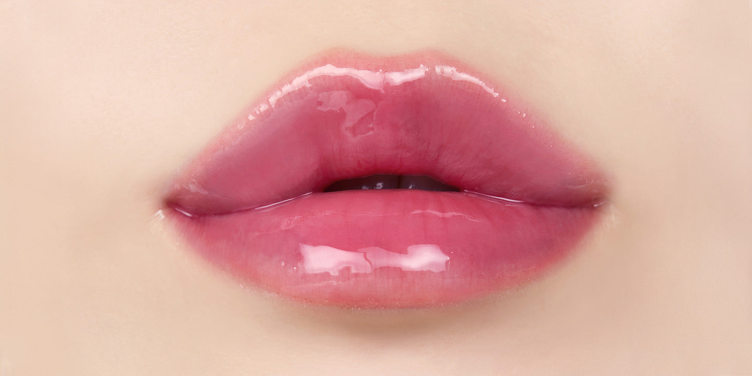 Close up of lips after applying nooni appleacaiberry lip oil with glossy shine and hydrated appearance.