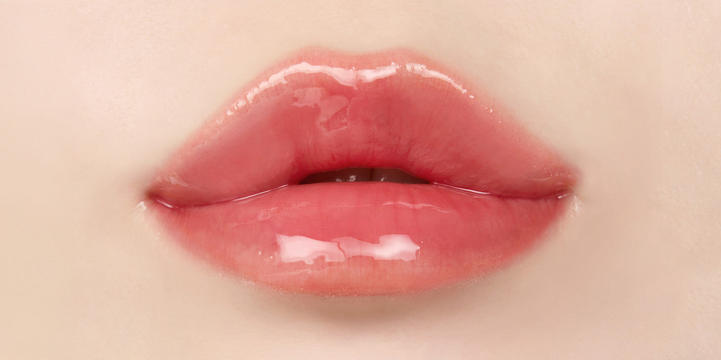Close up of lips after applying nooni appleguava lip oil with glossy shine and hydrated appearance.